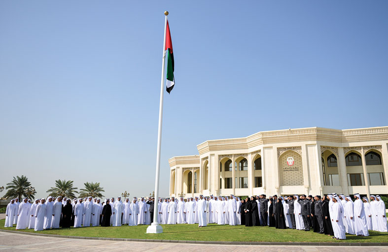 خالد بن محمد بن زايد يرفع علم الدولة أمام مبنى ديوان ولي العهد احتفاءً بيوم العلم
