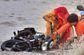 امرأة تنقذ سائق دراجة من فيضان مفاجئ